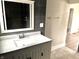 Modern bathroom with gray tile and updated vanity at 3563 Carrollton Ave, Indianapolis, IN 46205