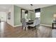 Bright dining room featuring a wood table and six gray chairs at 3735 Sunset Ridge Dr, Franklin, IN 46131