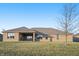 Brick house with covered patio and grassy yard at 5101 W Quincy Ct, Columbus, IN 47203