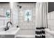 Black and white bathroom with subway tile and a white sink at 5162 Crittenden Ave, Indianapolis, IN 46205