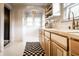 Kitchen features wood cabinets, white tile, and a checkered rug at 5162 Crittenden Ave, Indianapolis, IN 46205