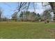 Large backyard with grassy area and trees at 5360 N Carroll Rd, Indianapolis, IN 46235