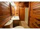 Bathroom with wood walls, shower, toilet and sink at 5360 N Carroll Rd, Indianapolis, IN 46235