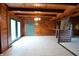 Dining area with wood walls, tile floor, and access to a deck at 5360 N Carroll Rd, Indianapolis, IN 46235