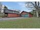 Rear view of log cabin home and detached garage at 5360 N Carroll Rd, Indianapolis, IN 46235