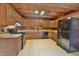 Kitchen with wood cabinets, black appliances, and tile floor at 5360 N Carroll Rd, Indianapolis, IN 46235