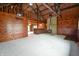 Living room featuring wood walls, cathedral ceiling, and a stone fireplace at 5360 N Carroll Rd, Indianapolis, IN 46235