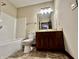 Bathroom with tub, toilet and dark wood vanity at 5375 E Commons West Dr, Mooresville, IN 46158