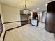 Bright dining area with tile flooring and view into the living room at 5375 E Commons West Dr, Mooresville, IN 46158