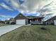 Brick ranch home with attached garage and landscaped yard at 5375 E Commons West Dr, Mooresville, IN 46158