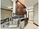 Kitchen features granite countertops, double sink, and dark wood cabinets at 5375 E Commons West Dr, Mooresville, IN 46158