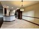 Kitchen with island, stainless steel appliances, and dark wood cabinets at 5375 E Commons West Dr, Mooresville, IN 46158