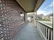 Covered side porch with brick exterior and neighborhood view at 5375 E Commons West Dr, Mooresville, IN 46158