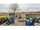 Relaxing fire pit area with blue Adirondack chairs and stone border at 6364 Meadowview Dr, Whitestown, IN 46075