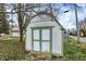 White shed with green trim offers extra storage space at 65 Central Ave, Franklin, IN 46131