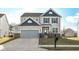 Two-story house with gray siding, a brick base, and a two-car garage at 6927 Park Grove Blvd, Whitestown, IN 46075