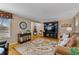 Living room with hardwood floors, comfortable seating, and a large flat-screen TV at 812 S School St, Brownsburg, IN 46112