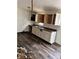 Kitchen with white cabinets, vinyl flooring, and a double sink at 8434 Meadowlark Dr, Indianapolis, IN 46226