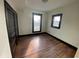 Bright bedroom featuring hardwood floors and large windows at 102 N Munsie St, Indianapolis, IN 46229