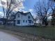 White house with green trim and picket fence, spacious yard at 102 N Munsie St, Indianapolis, IN 46229