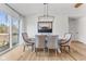 Elegant dining area showcasing a rustic-modern light fixture and hardwood floors at 10402 N State Road 9, Pendleton, IN 46064