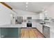 Modern kitchen featuring white cabinets, stainless steel appliances, and light wood flooring at 10402 N State Road 9, Pendleton, IN 46064