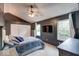 Primary bedroom with dark gray walls, large windows and a ceiling fan at 11064 Oakridge Dr, Fishers, IN 46038