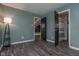 Subdued bedroom with wood-look flooring and access to the bathroom at 1128 Palo Vista Rd, Greenwood, IN 46143