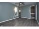 Bedroom with gray walls, dark flooring, and ceiling fan at 1128 Palo Vista Rd, Greenwood, IN 46143