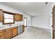 Kitchen with wood cabinets, granite countertops, and stainless steel appliances at 1607 Wilford Ln, Indianapolis, IN 46229