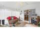 Relaxing sunroom featuring wicker furniture and access to the kitchen at 1645 Leerkamp Dr, Franklin, IN 46131