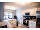 Modern kitchen with white cabinets, stainless steel appliances, and tile floors at 1844 Misty Lake Dr, Indianapolis, IN 46260