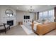 Living room with fireplace, large windows, and leather couch at 19063 Seaforth Way, Westfield, IN 46074