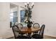 Charming dining room featuring a wood table, four chairs, and a large window at 19983 Chatham Green Dr, Westfield, IN 46074