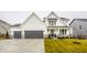 Two-story farmhouse with gray double garage and stone accents at 19983 Chatham Green Dr, Westfield, IN 46074