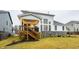 Rear view of house with stone accents and deck at 19983 Chatham Green Dr, Westfield, IN 46074