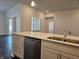 Kitchen island with white cabinets, stainless steel dishwasher, and quartz countertops at 2374 Riviera Pl, Greenwood, IN 46143