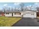 Newly renovated ranch home with white brick exterior, attached garage, and spacious lawn at 2555 S Ritter Ave, Indianapolis, IN 46203