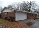 Brick ranch home with attached garage and picnic table at 3287 Melbourne Rd, Indianapolis, IN 46228