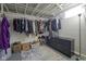 Well-organized basement closet with hanging rods and shelving at 33 S Post Rd, Indianapolis, IN 46219