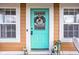 Quaint teal front door with a wreath, welcoming guests at 332 W Lincoln St, Danville, IN 46122