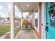 Front porch with a wooden swing and teal door at 332 W Lincoln St, Danville, IN 46122