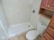 Clean bathroom with shower, toilet and wooden cabinet at 515 Churchman Ave, Beech Grove, IN 46107