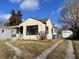 House exterior showcasing a spacious yard and detached garage at 5315 Norwaldo Ave, Indianapolis, IN 46220