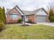 Brick ranch home with gray siding, landscaped lawn, and attached garage at 5628 Mead Ct, Indianapolis, IN 46220