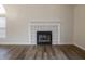 Modern fireplace with patterned tile surround and dark hardwood floors at 5628 Mead Ct, Indianapolis, IN 46220