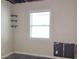 Unfinished bedroom with new window and floating shelves at 5701 Regency Dr, Indianapolis, IN 46224