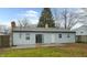 Ranch house with gray siding, patio, and fenced backyard at 5701 Regency Dr, Indianapolis, IN 46224