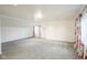 Spacious bedroom with grey carpet and floral curtains at 5708 Kingsley Dr, Indianapolis, IN 46220