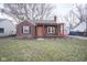 Brick house with a pergola and a red door at 5708 Kingsley Dr, Indianapolis, IN 46220